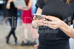 Businesswoman text messaging on smartphone