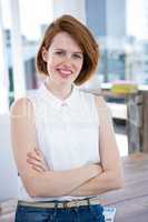 smiling hipster business woman with her arms crossed