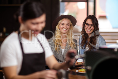 Smiling friends enjoying coffee