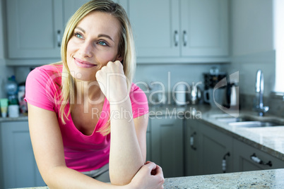 Pretty blonde woman leaning on the counter