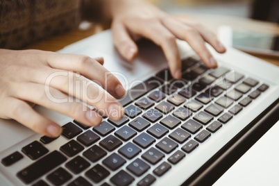 Close up of hands typing on a laptop