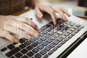 Close up of hands typing on a laptop