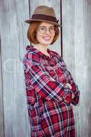 smiling hipster woman with her arms crossed