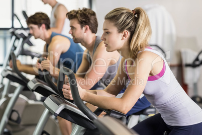 Fit people doing exercise bike