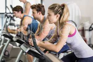 Fit people doing exercise bike