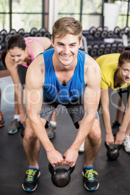 Fitness class lifting dumbbells