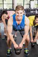 Fitness class lifting dumbbells