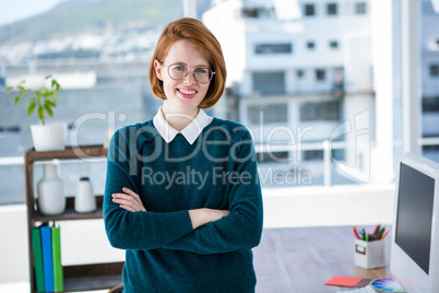 smiling hipster business woman with her arms crossed