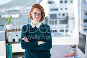 smiling hipster business woman with her arms crossed