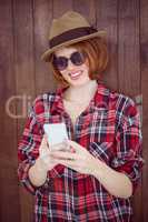 smiling hipster woman on her smartphone