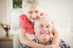 Senior woman embracing man at home