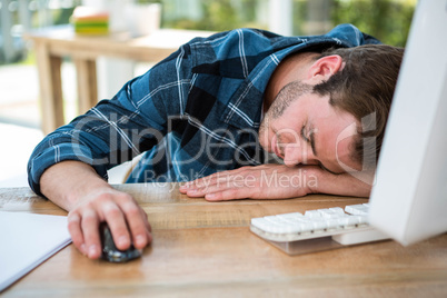 Handsome man sleeping on computer