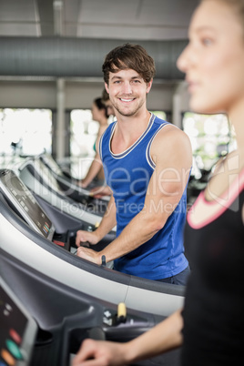 Athletic man running on treadmill