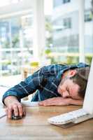 Handsome man sleeping on computer