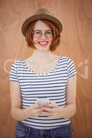smiling hipster woman holding  a mobile phone