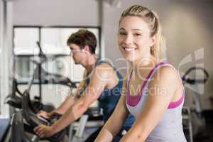 Fit woman doing exercise bike