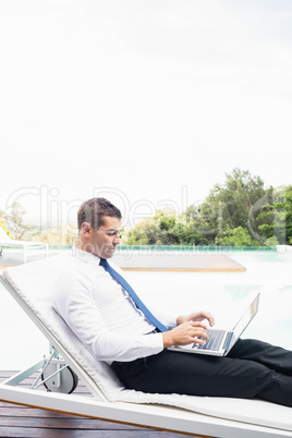 Smarty dressed man using laptop