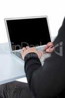 Handsome man in black hoodie using laptop