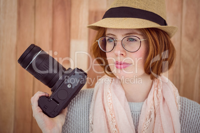 Hipster smiling and holding camera