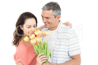 Smiling couple with flowers bouquet