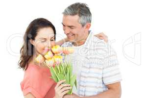 Smiling couple with flowers bouquet