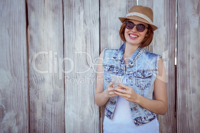 smiling hipster woman on her smartphone