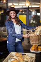 Smiling woman holding bread basket