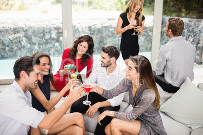 Group of friends toasting cocktail drinks