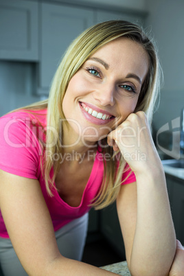 Pretty blonde woman leaning on the counter