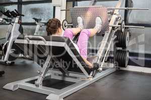 Pregnant woman using weight machine