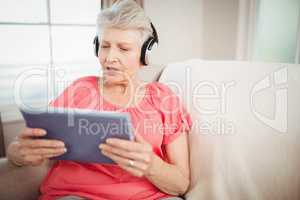 Happy senior woman listening to music