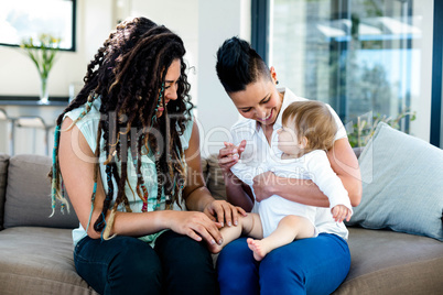 Lesbian couple playing with their baby