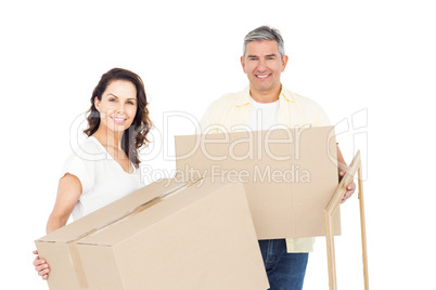 Happy couple carrying box