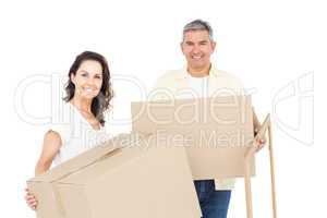 Happy couple carrying box