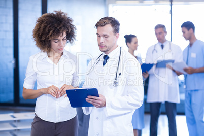 Doctor and colleague looking at medical report