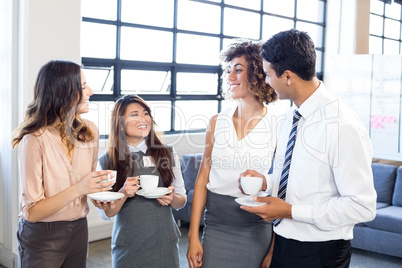 Businesspeople interacting in office during breaktime