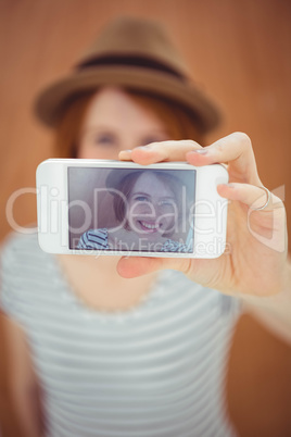 smiling hipster woman taking a selfie