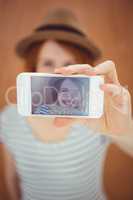 smiling hipster woman taking a selfie