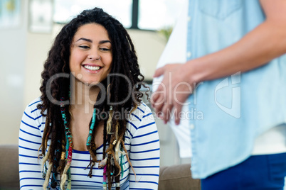 Woman looking at her pregnant partners belly