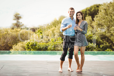 Young couple enjoying near poolside