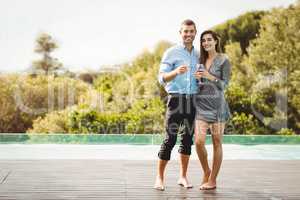 Young couple enjoying near poolside