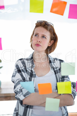 thoughtful hipster woman brainstorming over notes