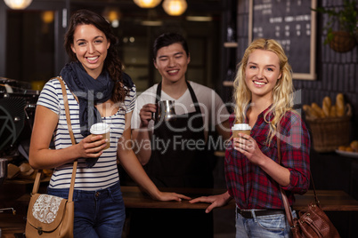 Smiling friends enjoying coffee