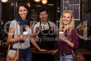 Smiling friends enjoying coffee