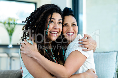 Happy lesbian couple embracing each other and smiling