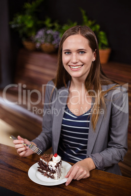 Woman about to eat a piece of cake