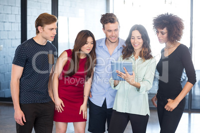 Colleagues looking in digital tablet