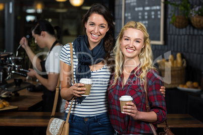 Smiling friends enjoying coffee