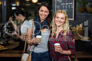 Smiling friends enjoying coffee