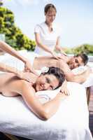 Young couple receiving a back massage from masseur